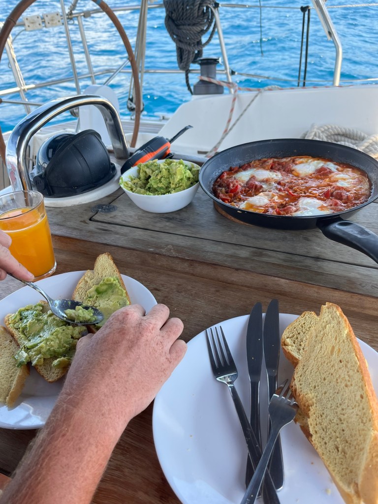 Cooked breakfast onboard sailing yacht at sea