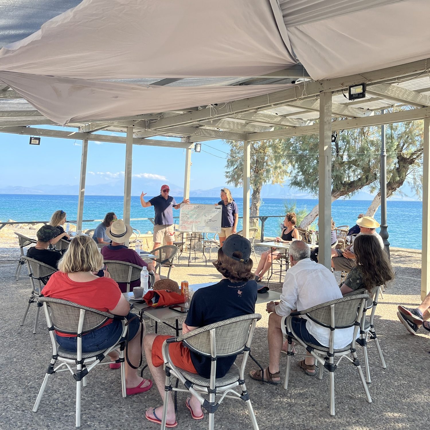 Group of people listening to a sailing briefing